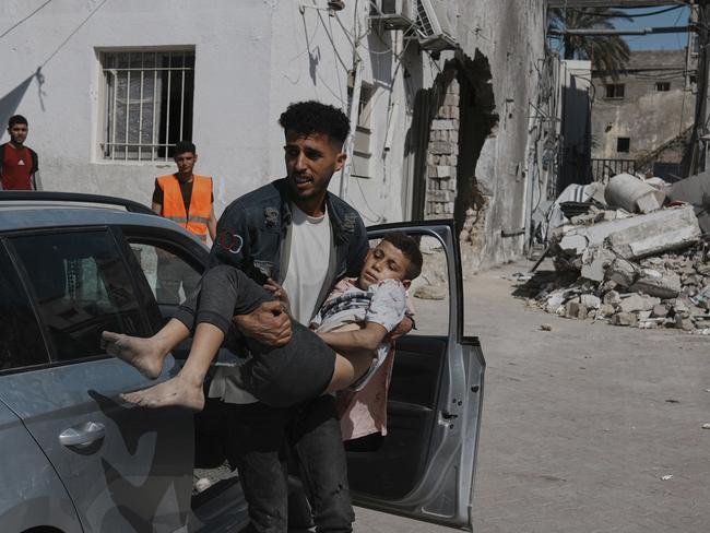 A Palestinian boy, injured following an Israeli air strike, is brought for treatment to the Baptist Hospital in Gaza City. Picture: Jehad Alshrafi / AP Photo