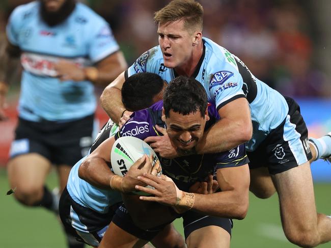 MELBOURNE, AUSTRALIA - APRIL 16: Reimis Smith of the Storm is challenged by Teig Wilton of the Sharks during the round six NRL match between the Melbourne Storm and the Cronulla Sharks at AAMI Park, on April 16, 2022, in Melbourne, Australia. (Photo by Robert Cianflone/Getty Images)