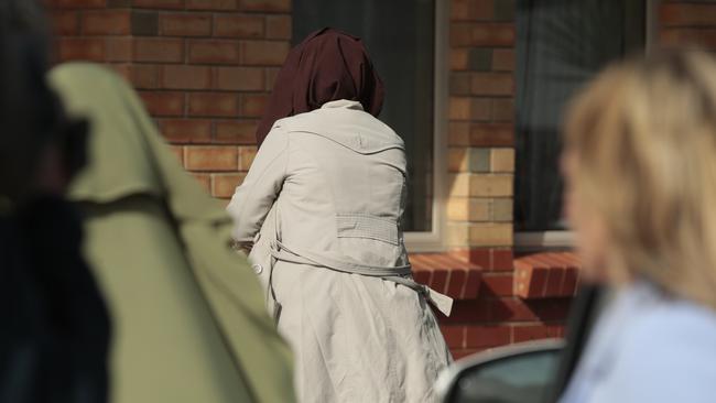 A woman enters the arrested woman’s Adelaide address. Picture: Tait Schmaal