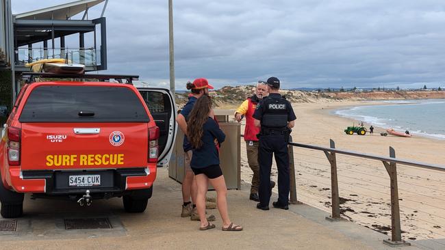 Police and Surf Rescue personnel at Port Noarlunga after the shark attack on Thursday. Picture: Darren Chaitman