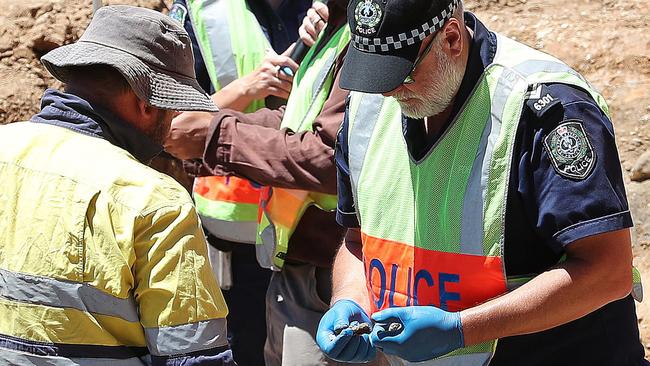 Police examine items unearthed during the dig at the Castalloy factory. Picture: Dylan Coker