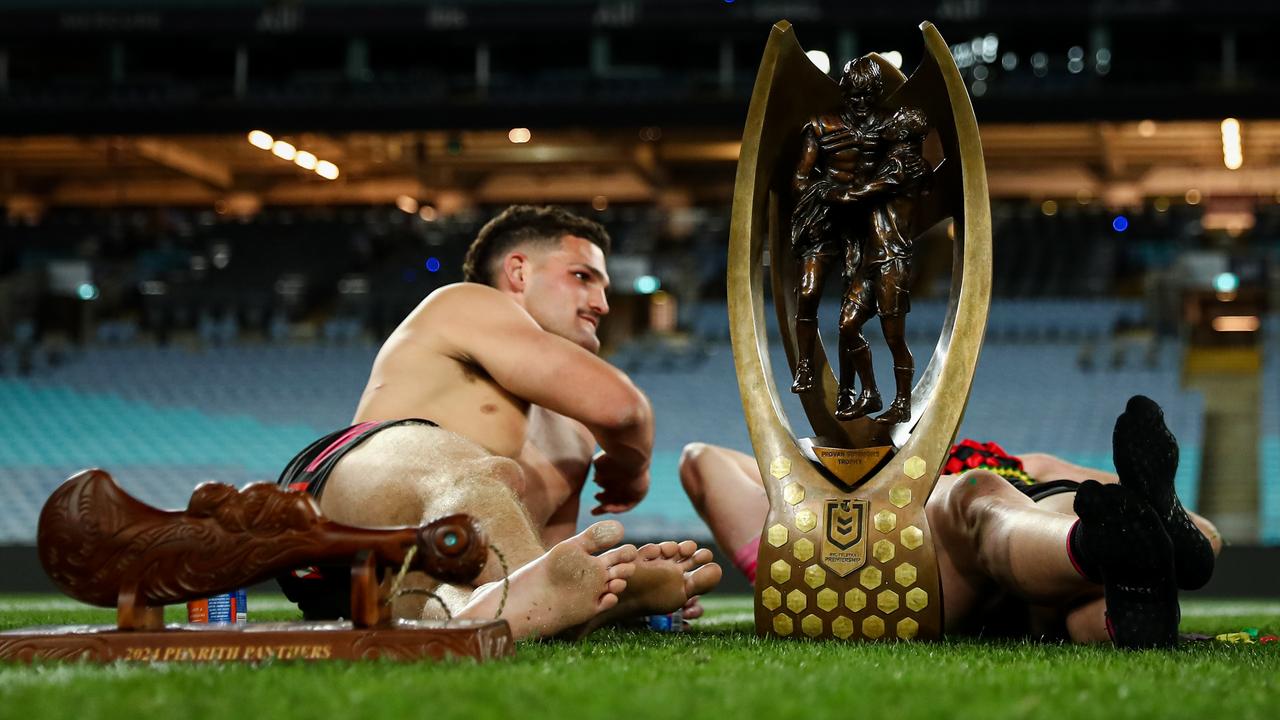 Nathan Cleary has a moment with the Provan-Summons trophy on the field.