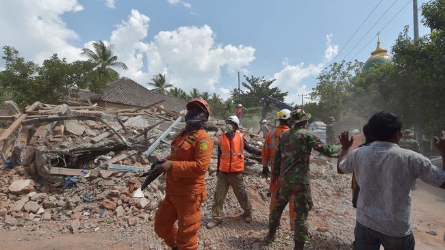 Not again: Indonesian search and rescue members react shortly after an aftershock hits the area in Tanjung on Lombok island on Thursday. Picture: Adek Berry/AFP