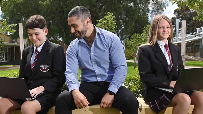 Underdale High school students Quinn McMorrow and Isla Mitchell go digital under guidance from year level leader Peter Savvas. Picture: Keryn Stevens