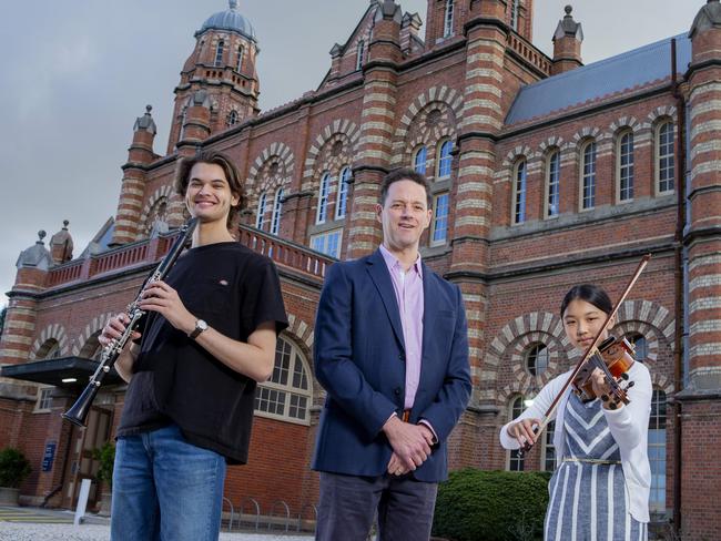 Queensland Youth Orchestra conductor and director of music Simon Hewett with  musicians Lewis Blanchard   (left) and  Katie Ton (right) outside of the Queensland Youth Orchestra facility in Bowen Hills.    Picture: Jerad Williams