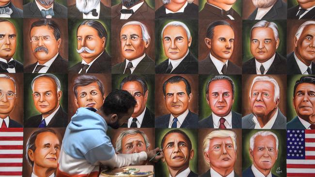 A painter gives the final touches to a painting depicting former US President Barack Obama in Amritsar on November 8. Picture: AFP