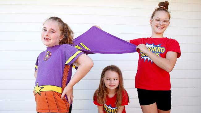 Indyana Wedderburn models the 'Supertee' with sisters Pypah-Joy and Kylah. Picture: Toby Zerna