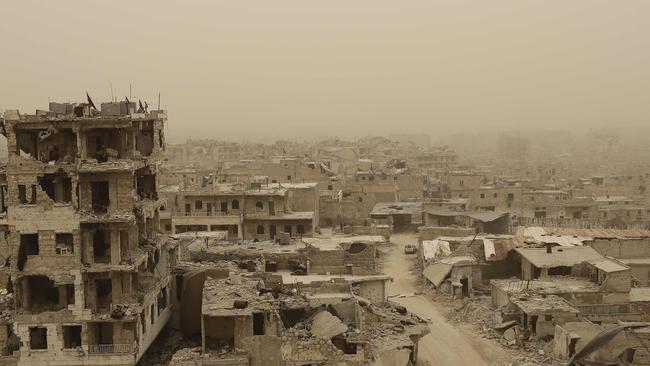 A picture taken during a sandstorm shows destruction in the once rebel-held Karm al-Jabal neighbourhood in the northern city of Aleppo. Picture: Joseph Eid.