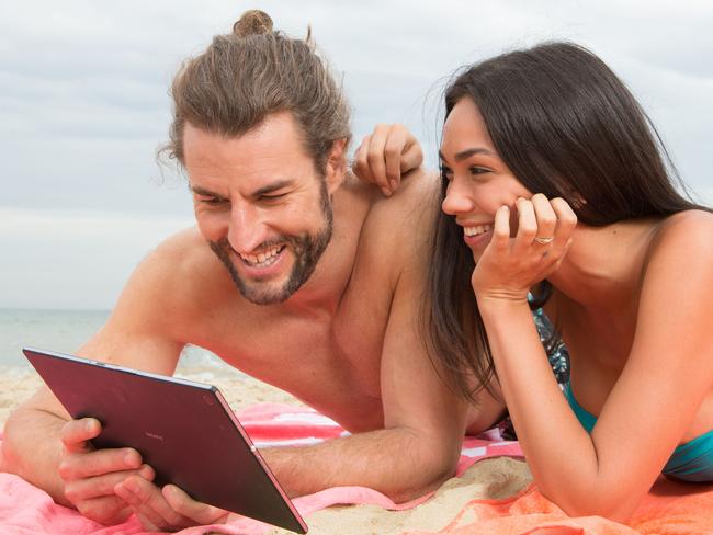 Generic photo supplied by Telstra of couple/people using a mobile device/tablet/smartphone