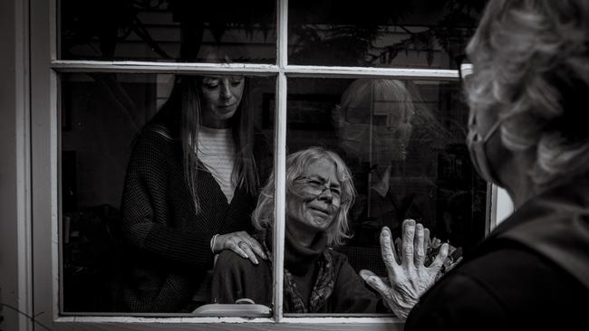 Robyn Becker, in the final stages of terminal cancer, farewells her sister Jennifer, who has flown from California to Melbourne. Jennifer quarantined for two weeks but was given special leave to visit. Robyn would sadly pass away on July 10, seven weeks later. Picture: Christopher Hopkins/The Age