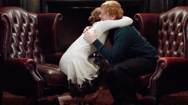 Emotional moment: Emma Watson embraces former co-star Rupert Grint.