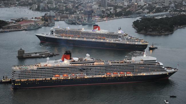 Queen Elizabeth (foreground) follows larger sister ship Queen Mary 2 into Sydney Harbour as Mary makes her way to dock at Garden Island while Elizabeth is on her way to Overseas Passenger Terminal at Circular Quay in 2011.