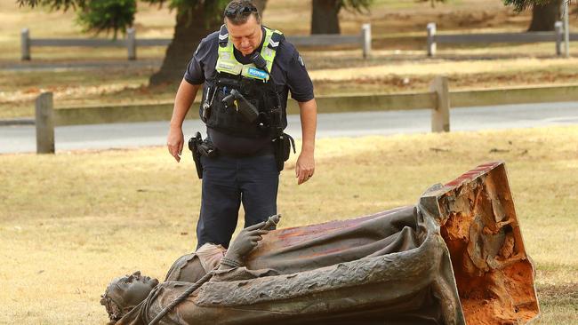 Police investigate damage to the Queen Victoria statue in Eastern Gardens. Picture: Alison Wynd