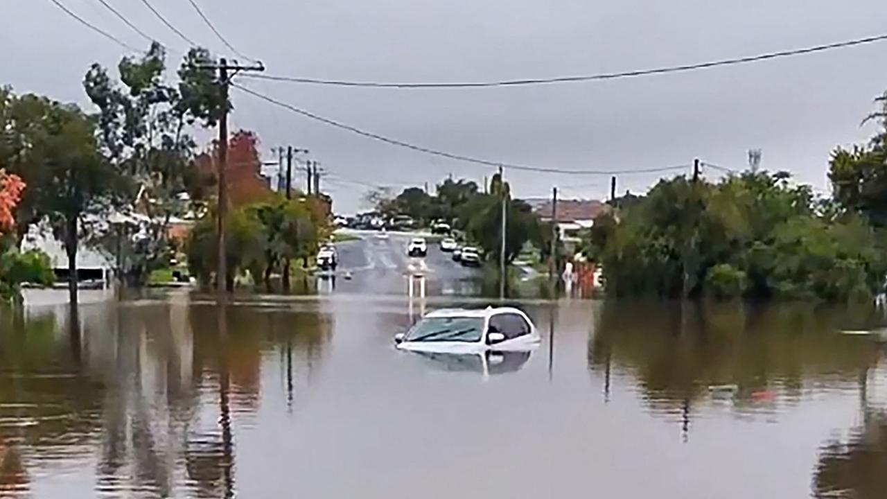 A car submerged in a flooded area in the New South Wales town of Taree. Picture: AFP