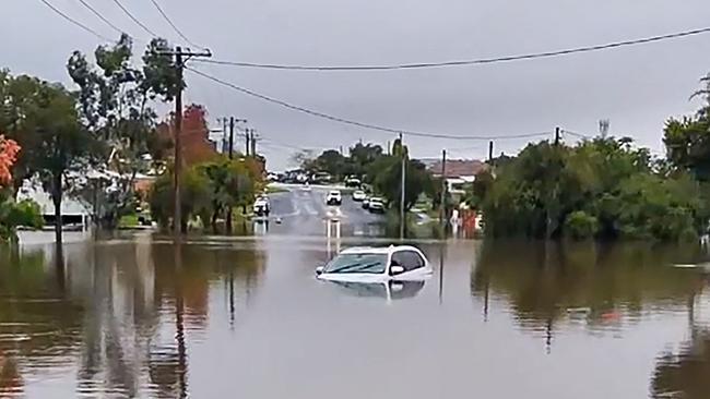 A car submerged in a flooded area in the New South Wales town of Taree. Picture: AFP