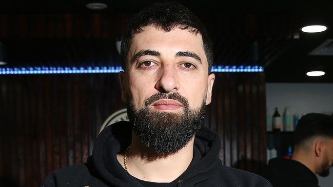 Anmol Nabil Jameel is a refugee who escaped persecution in Iraq. He came to Australia with his family in 2019 and now owns a popular barber shop in Corio Village. Picture: Alan Barber