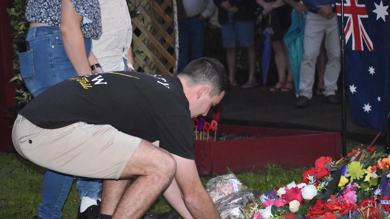 A person laying a wreath for the ANZACs at the Kuttabul dawn service at the Hampden State School Remembrance Garden 2021. Picture: Lillian Watkins