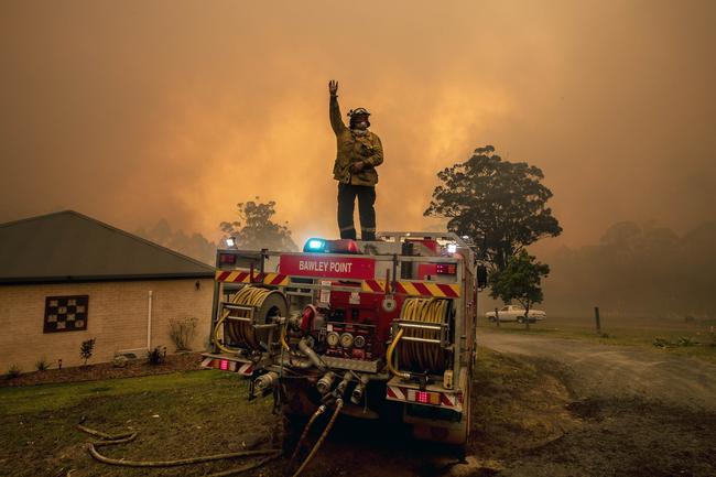 RFS firefighters desperately worked to save a home on Willinga Drive at Bawley Point, on the NSW south coast. Picture: Gary Ramage