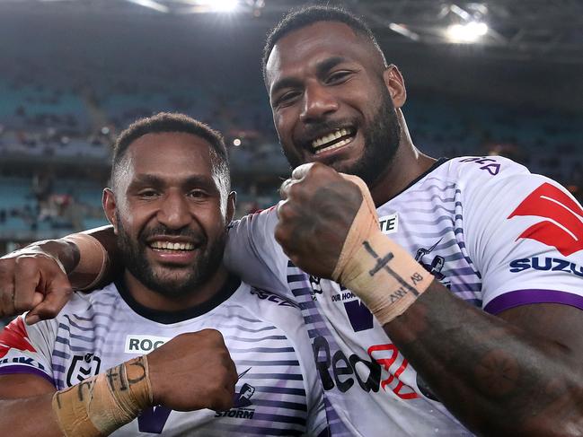 SYDNEY, AUSTRALIA - OCTOBER 25:  Justin Olam of the Storm and Suliasi Vunivalu of the Storm celebrate following the 2020 NRL Grand Final match between the Penrith Panthers and the Melbourne Storm at ANZ Stadium on October 25, 2020 in Sydney, Australia. (Photo by Cameron Spencer/Getty Images)