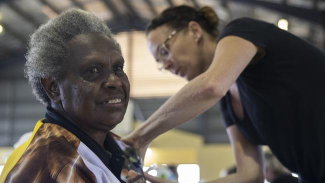 Rosie Gibuma receives the vaccine at the Boigu Island community centre from Queensland Health nurse Ruth Ferguson. Picture: Getty Images