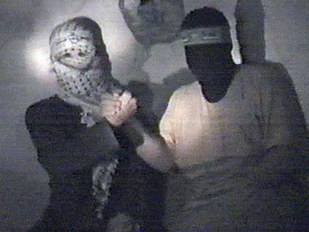 A file image of a video released by Hamas in 2004 shows masked militants shaking hands in a tunnel beneath Gaza.