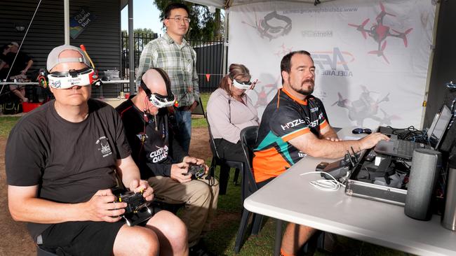 At Woodville North, race director Jeremy Porter at the console, with pilots David Hoyle, David and Sue Guscott, and organiser Joseph Tan. Picture: Dean Martin