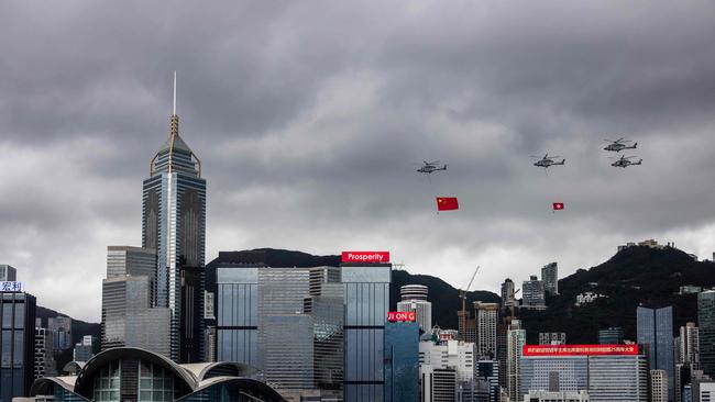 Helicopters fly past with the Hong Kong and Chinese flags on Friday. Picture: AFP