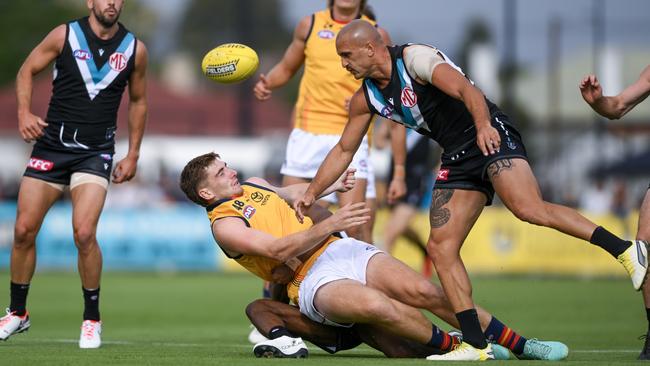 Mark Keane of the Crows tackled by Willie Rioli of the Power and Sam Powell-Pepper of the Powerduring an AFL practice match between Port Adelaide Power and Adelaide Crows at Alberton Oval on February. Picture: Mark Brake/Getty Images