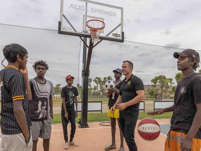 26/04/2023: Alice Springs based Yipirinya School principal Gavin Morris with students on the school grounds. Jahquille Stuart (rat tail), Malikai Hayes, Keylin Peters (red cap), Akiel Douglas (blue cap) and Adrian Nelson (black cap). PIC: Grenville Turner