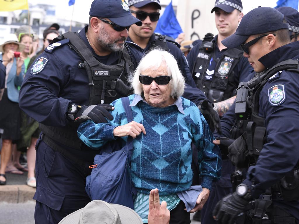 A woman is arrested in Brisbane after activists took over a bridge. Picture: AAP Image/Dave Hunt