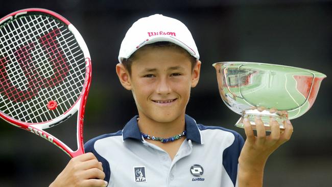 A young Bernard Tomic in 2005 with the the Orange bowl trophy he won in the United States.