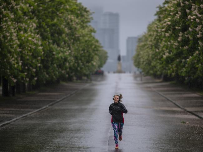 A lone jogger runs in an empty park in London. Picture: Getty Images