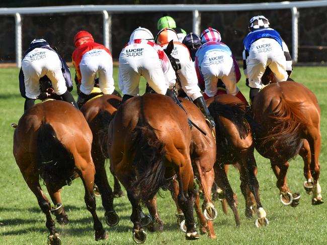 Jockeys are seen leaving the straight in the Adapt Australia Handicap during Christmas At The Valley at Moonee Valley Racecourse in Melbourne, Saturday, December 1, 2018. (AAP Image/Quentin Lang) NO ARCHIVING, EDITORIAL USE ONLY