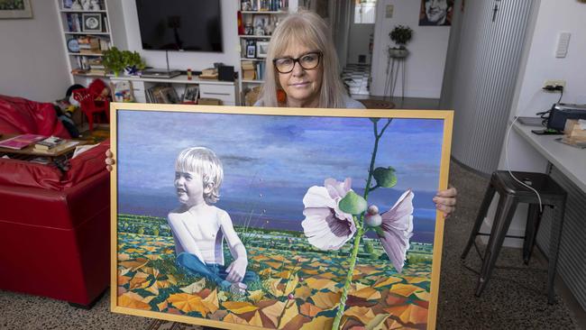 Angela Vaskin holding a painting of Josh painted by Artist Kim Polomka. Picture: Kelly Barnes