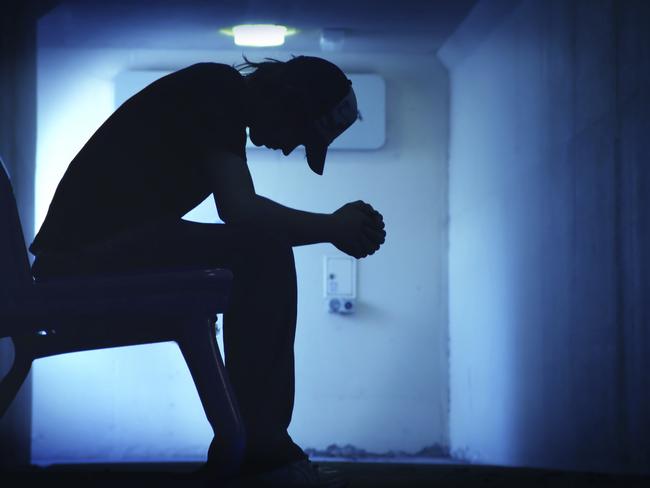 Young man with hands clasped together