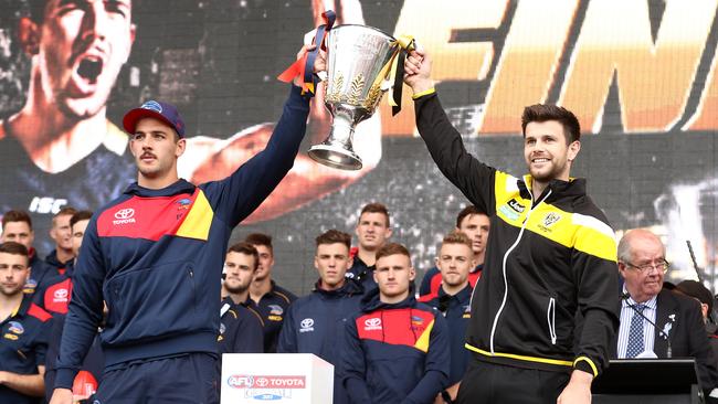 Taylor Walker and Trent Cotchin get their hands on the cup. Picture: Getty Images