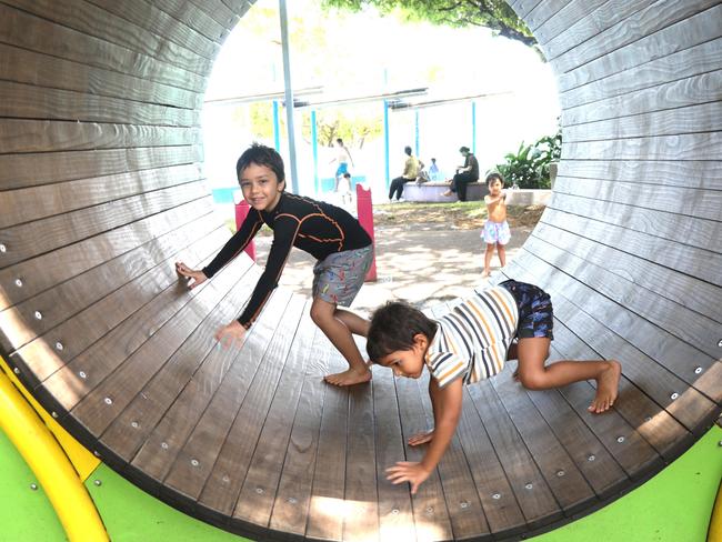 Brothers Jonty and Alby Rungan stay cool, playing in the shade at Muddy's Playground. Photo: Catherine Duffy