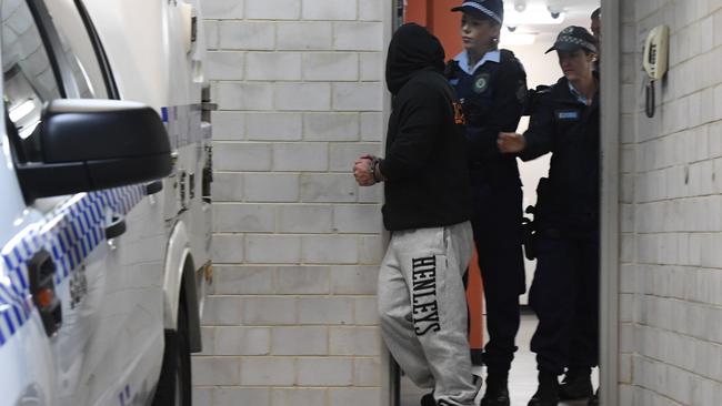 Tow truck driver Moustafa Salami is escorted from Kogarah Police Station on Saturday. Picture: Gordon McComiskie