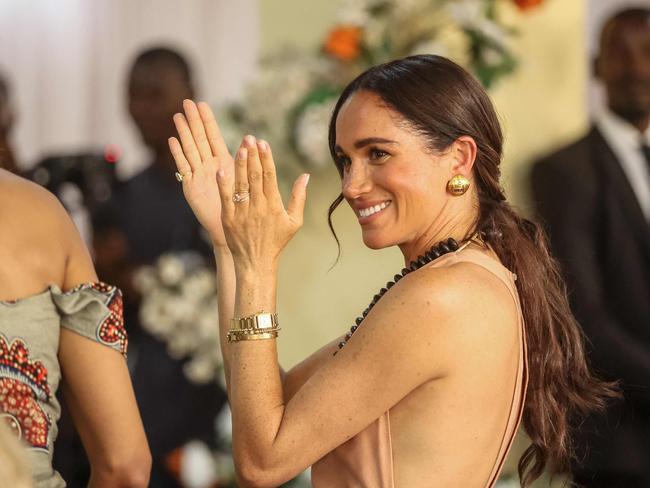 Britain's Meghan, Duchess of Sussex, gestures as she arrives with Britain's Prince Harry (unseen), Duke of Sussex, during their visit at the Lightway Academy in Abuja on May 10, 2024 as they visit Nigeria as part of celebrations of Invictus Games anniversary. (Photo by Kola SULAIMON / AFP)