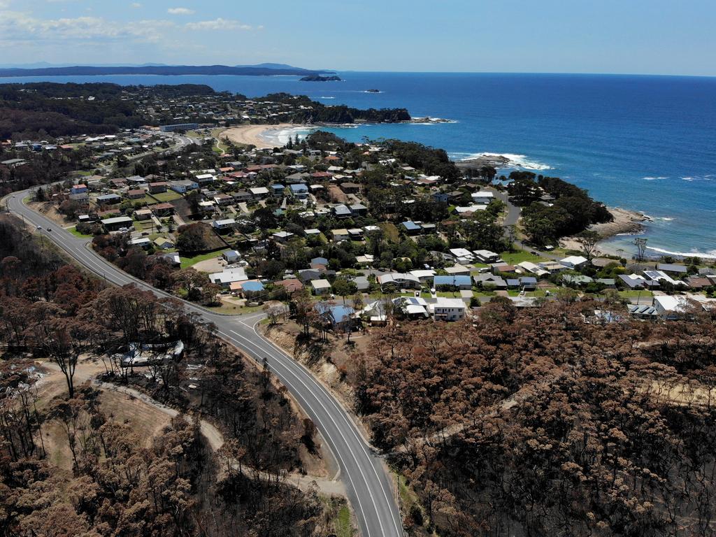 Homes in Malua Bay were randomly destroyed by the New Years Eve fire storm while others were left virtually untouched. A property off George Bass Drive (L) in between Pretty Point and Mackenzies Beach was destroyed while homes along Illabunda Drive were left untouched. Picture: Toby Zerna