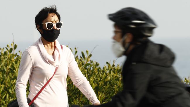 Locals wear masks in St Kilda. Police issued 23 fines to non-mask wearers on Sunday. Picture: Darrian Traynor/Getty Images