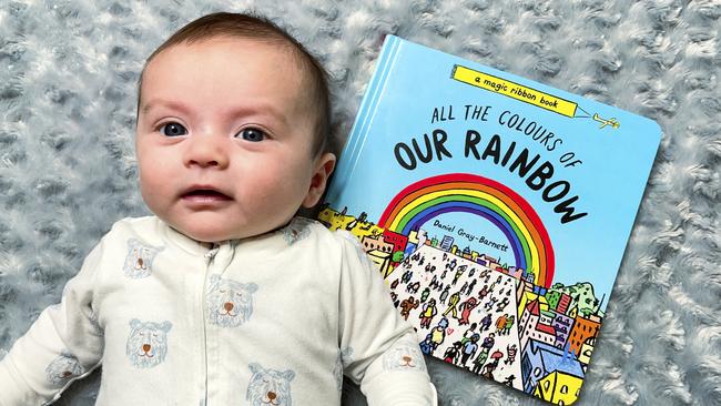 Baby Till Barnett with a new book called All the Colours of Our Rainbow, written and illustrated by one of his dads Daniel Gray-Barnett. Picture: Supplied.