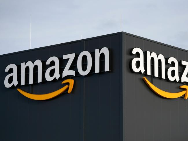 (FILES) In this file photo taken on December 17, 2019, this picture shows the logo of US online retail giant Amazon at the distribution center in Moenchengladbach, western Germany. - Amazon says it will invest $10 billion for  its planned space-based internet delivery system after winning US regulatory approval to deploy more than 3,000 low-orbit satellites. The US tech giant said on July 31, 2020 it is moving forward with its Project Kuiper, one of several systems planned to bring internet to customers without land-based connections. (Photo by INA FASSBENDER / AFP)