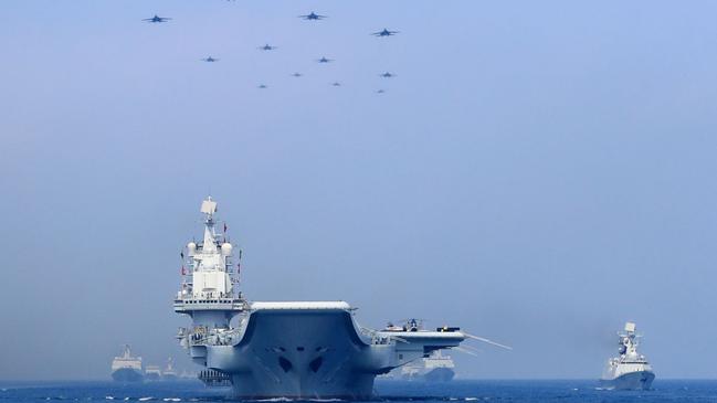 Chinese warships and fighter jets take part in a military display in the South China Sea. Picture: Reuters