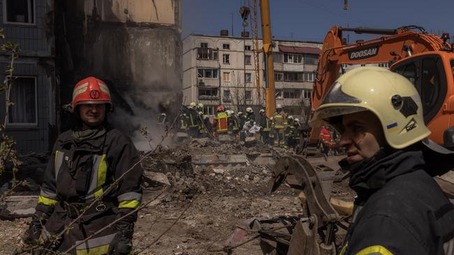 Firefighters work on the site of a destroyed residential building in Uman on Friday. Picture: Getty Images