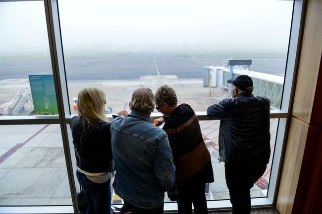 Travellers wait at Adelaide Airport for their flights to arrive. Picture: AAP / Brenton Edwards