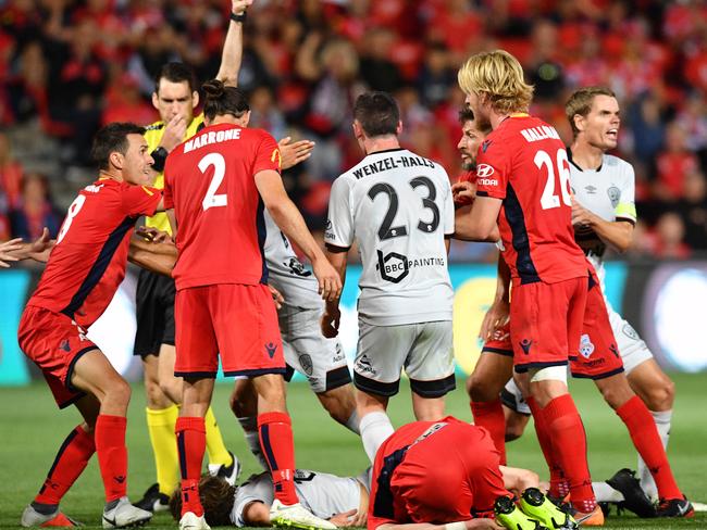 Players clash after Stefan Mauk of Brisbane Roar is injured during the Round 6 A-League match between Adelaide United and Brisbane Roar at Coopers Stadium in Adelaide, Friday, November 30, 2018. (AAP Image/David Mariuz) NO ARCHIVING, EDITORIAL USE ONLY