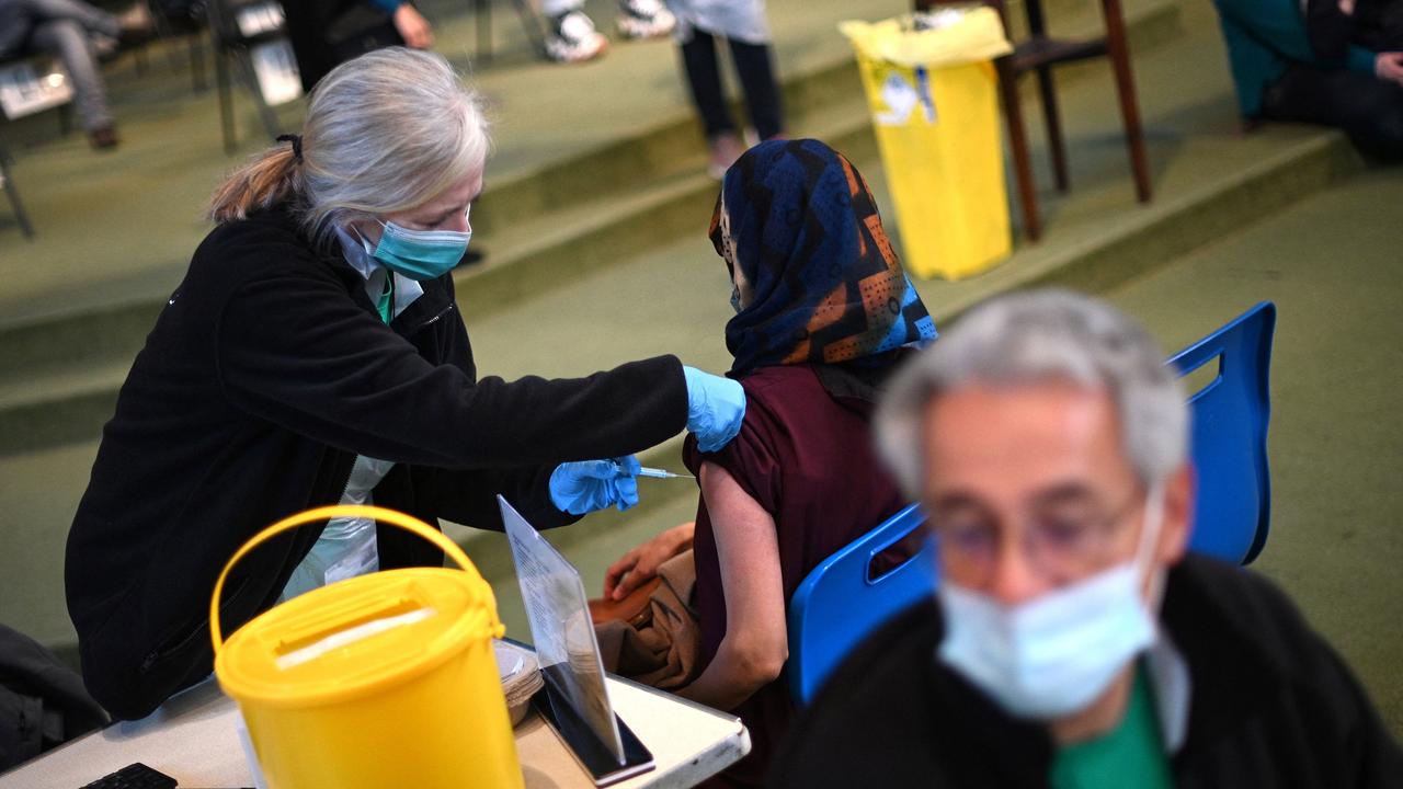 A member of the public receives a dose of a Moderna Covid-19 booster vaccine. Picture: AFP.