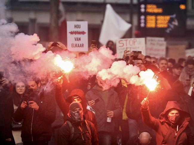 Demonstrators burn flares in a protest against Covid-19 measures in Brussels. Picture: AFP