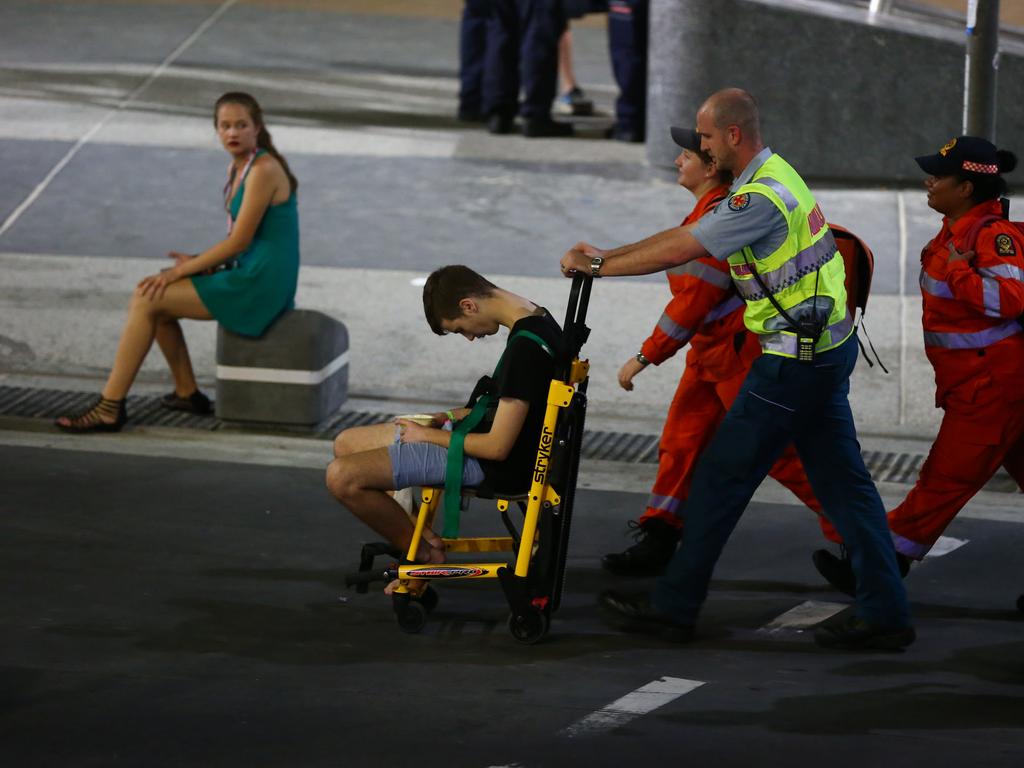 One reveller is taken away by security after enjoying themselves a little too much on a Tuesday Night at Schoolies Week on the Gold Coast. Picture: David Clark